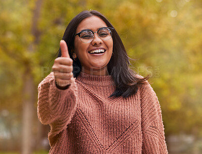 Buy stock photo Thumbs up, support and woman with smile in a park for peace, relax and happiness. Portrait of a happy, young and winning girl with hand sign for thank you, motivation and agreement in nature
