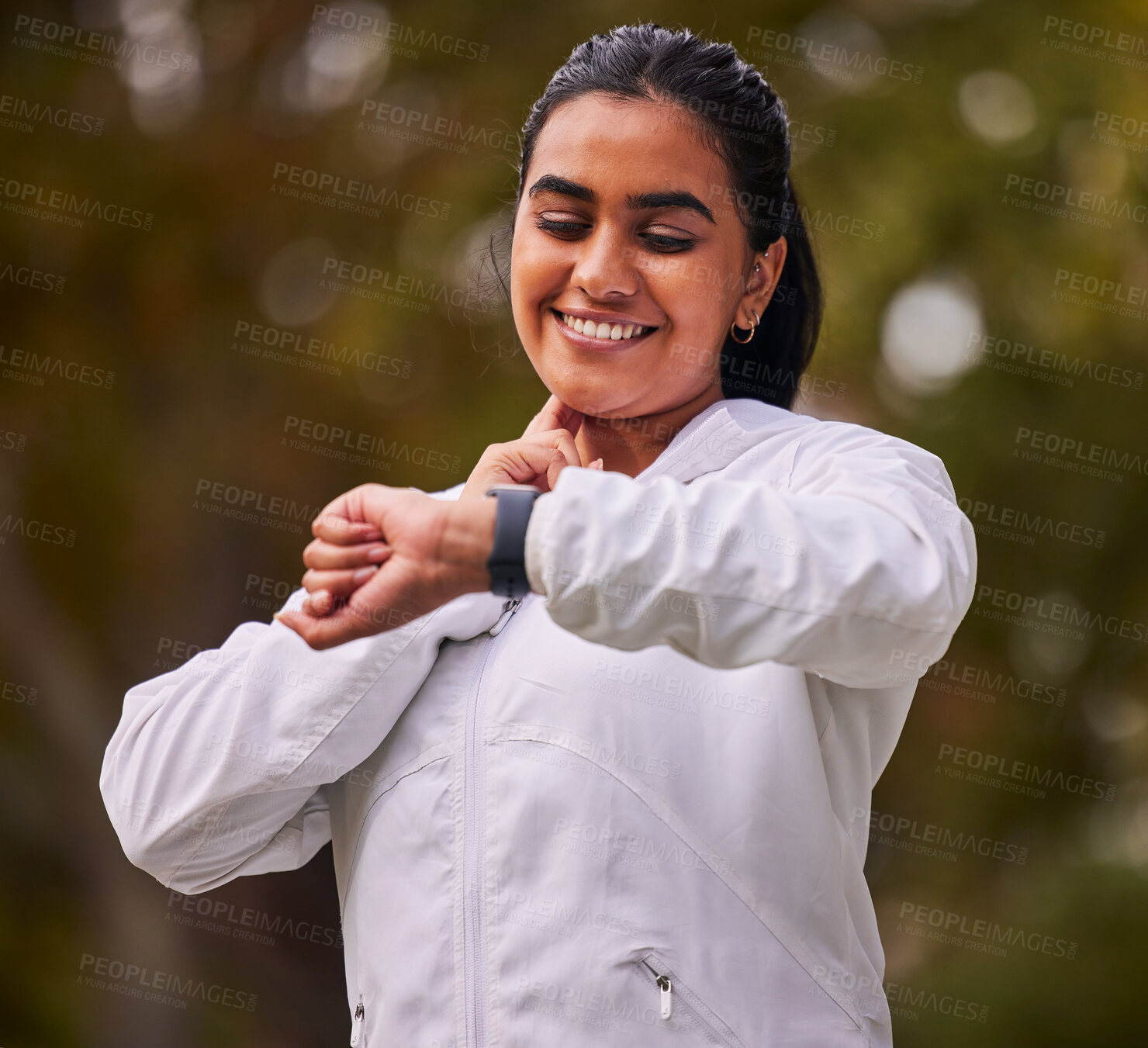 Buy stock photo Pulse, fitness and woman running in the park, on a break to check heart rate on sports watch. Indian girl doing exercise, training and workout in nature for wellness, cardio and healthy lifestyle