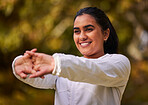 Fitness, exercise and wellness woman stretching and warm up for workout, running and cardio training outdoor in nature. Happy indian athlete female out for a run in a park for a healthy lifestyle