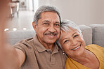 Selfie, couple and love with a senior man and woman sitting on the sofa of their home together for a photograph. Portrait, love and smile with elderly pensioners taking a picture in the living room