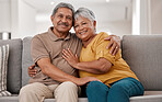 Hug, portrait and senior couple on the sofa in the living floor to relax during retirement in their house. Happy, smile and love from elderly man and woman with affection on the couch in their home