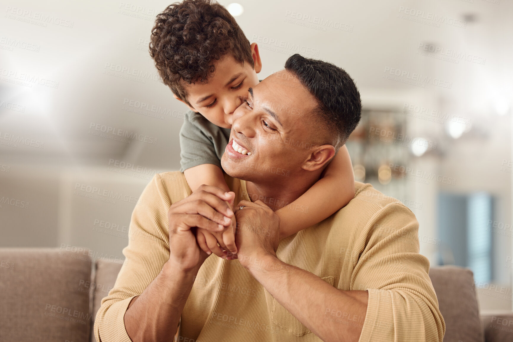 Buy stock photo Kiss, child and father with hug on the sofa for love, care and happiness in the living room together in their house. Young, happy and kid with smile, affection and hugging his dad on the couch