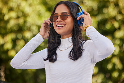 Buy stock photo Happy, woman and headphones listening to music for fun online audio streaming in the nature outdoors. Stylish female enjoying quality track with headset for stress relief, weekend and relax at a park