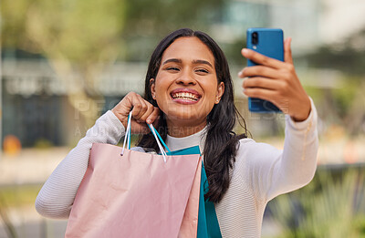 Buy stock photo Phone, selfie and shopping with woman in a city with happy, relax and smiling shopper holding shopping bags. Retail, fashion and social media influencer sharing good news, sale and discount online