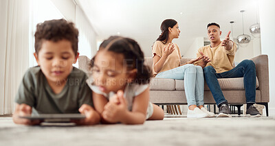 Buy stock photo Mother, father and disagreement on living room sofa while children are playing with tablet on the floor at home. Mama and dad fighting, argue or conflict in difficult situation on couch in dispute