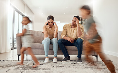Buy stock photo Headache, noise and stress with family in living room and parents overwhelmed by adhd kids energy. Tired, burnout and man, woman and hyper active children running in house, having fun or playing game