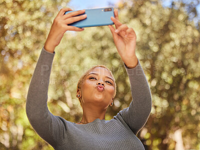 Buy stock photo Black woman, phone and selfie with pout in park with sunshine, summer and happiness by trees. Woman, smartphone and lips in kiss for photo, outdoor and nature with face in happy, funny and relax time