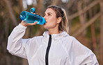 Fitness, health and runner woman with water bottle for hydration break on cardio run in nature. Training, running and healthy lifestyle of athlete girl with drink for workout, exercise and sport.