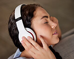 Woman face, music headphones and peace on living room sofa, relax and freedom, calm lifestyle or mindfulness. Happy young girl listening to meditation audio, radio or sleeping sound in apartment home