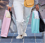 Retail, gift and shopping with hands of woman and walking on stairs for fashion, present or sales deal. Store, market or boutique bag with customer on steps in outdoor for luxury, product or service