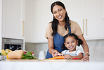 Happy family, girl or child learning from mother cooking or kitchen skills with healthy organic food vegetables. Smile, development and mom teaching or helping young kid with lunch or dinner at home