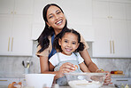 Mother, baking and bonding of a girl with mama learning in a home kitchen with a smile. Portrait of a happy black mom with happiness, love and care holding her kid in a house together smiling