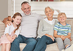 Grandparents, grandkids and being happy, relax and smile together on sofa in living room. Portrait, grandfather and grandmother with grandchildren for love, bonding and happiness on couch in lounge.