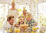 Kids happy birthday party, confetti surprise and family home with cake, celebration and happiness in Australia house together. Excited children, smile parents and grandparent celebrate special event 