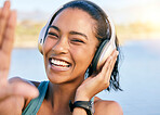 Happy woman, headphones and music while outdoor in nature for exercise, relax and fun listening to podcast, radio or song. Portrait of female using wireless technology to streaming audio on workout