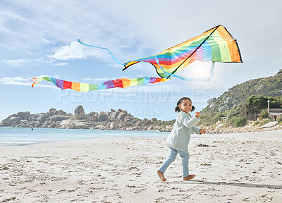 Buy stock photo Beach, smile and girl running with kite on holiday, vacation or trip outdoors having fun. Energy, happy and child from South Africa playing with colorful toy airplane on sandy, sea or ocean shore.