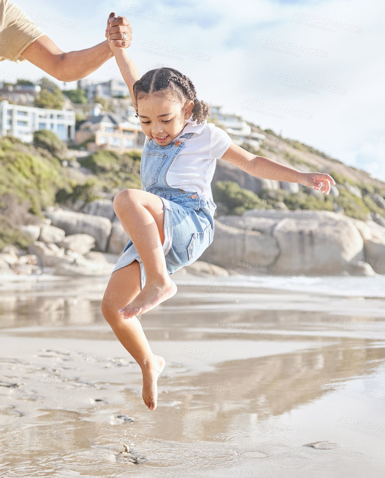 Buy stock photo Summer, family and girl at the beach with arm of dad lifting her in water, having fun and bonding on travel vacation. Love, happy and ocean wave by child and parent playing in sea, happy and relax