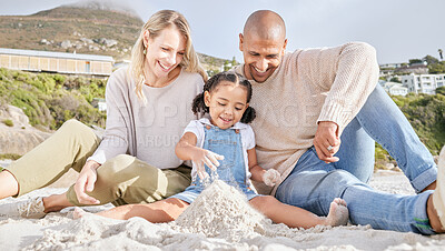 Buy stock photo Happy, beach and family with castle in sand for summer, freedom and travel vacation together. Love, smile and relax with mother and father playing with girl for holiday, lifestyle and building