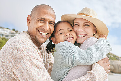 Buy stock photo Mom, dad and child hug at the beach on family vacation, holiday and enjoying weekend. Love, affection and multicultural parents with happy girl in portrait smile, bond and embrace by ocean together