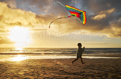 Buy stock photo Kite, child and beach fun of a kid running by the ocean waves at a summer sunset. Boy run on the sea sand in nature enjoying vacation, youth travel and flying outdoor happy, relax and content