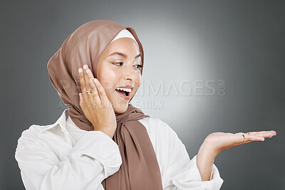 Buy stock photo Hijab, surprise or islam woman show advertising space or marketing mock up for fashion, cosmetics or retail sale design Muslim, arabic and wow face of girl model with hand sign for mockup in studio