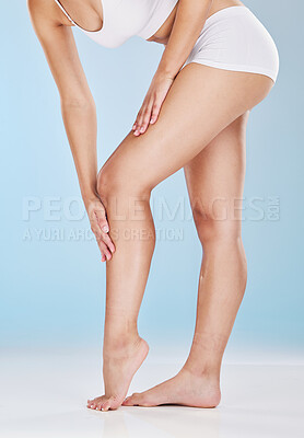 Buy stock photo Woman, legs and skincare moisturizer of a model using lotion, cream and skin leg treatment. Beauty, cosmetic and well being health care of a person touching a body to feel smooth hair laser treatment