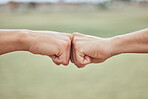 Fist bump, hands and people together to show support, solidarity and achievement success outdoor. Friends hand gesture show community friendship, excited victory or goal collaboration in nature 