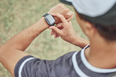 Fitness, man and watch monitoring sports workout, exercise or training in the nature outdoors. Active male in healthy sport checking wrist technology for time, cardio or pulse in athletic exercising