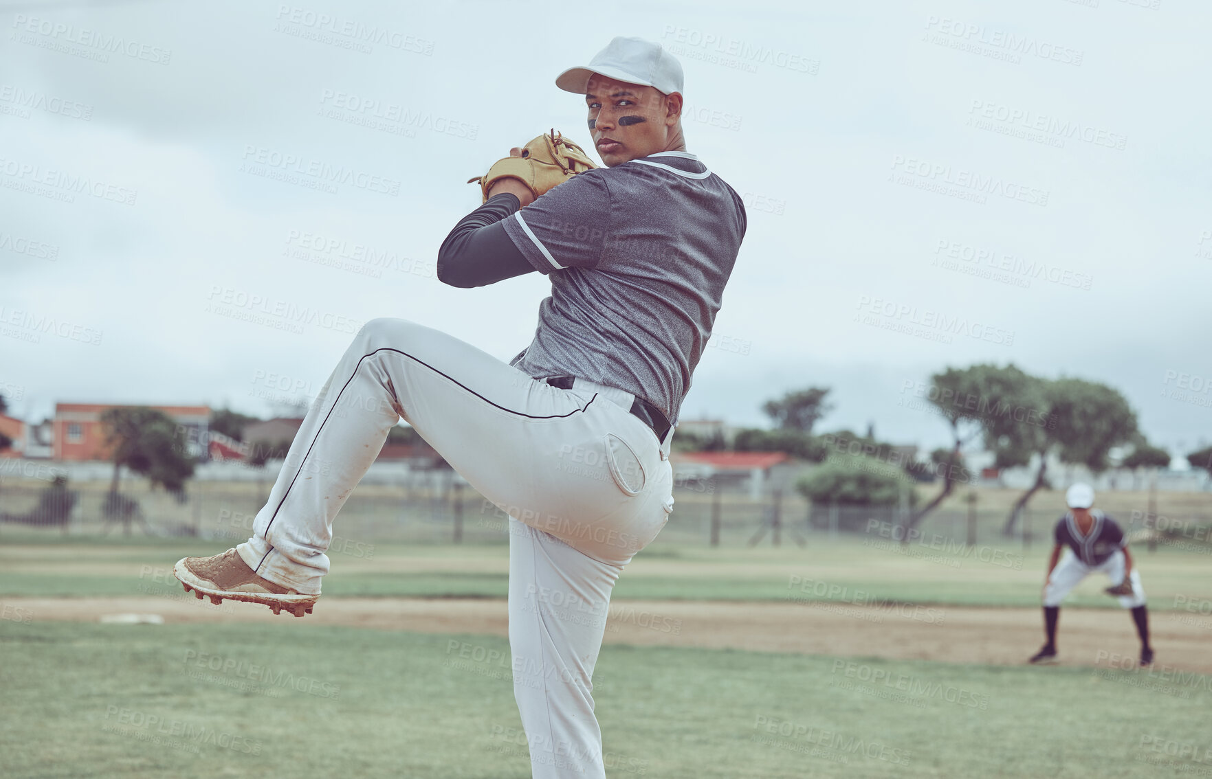 Buy stock photo Baseball, sports and man throwing a ball during a professional game on a field with a team. Athlete pitching during an event for sport, competition or training with focus, balance and speed at a park