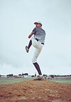 Man, baseball and pitcher in sports throw or competitive match to score point or win on the field outdoors. Professional baseball player in sport stance ready to pitch the ball in serious competition