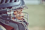 Baseball, sport and helmet with a sports man on a grass pitch or field during a game for exercise or fitness. Workout, training and competition with a male athlete playing sport at an outdoor event
