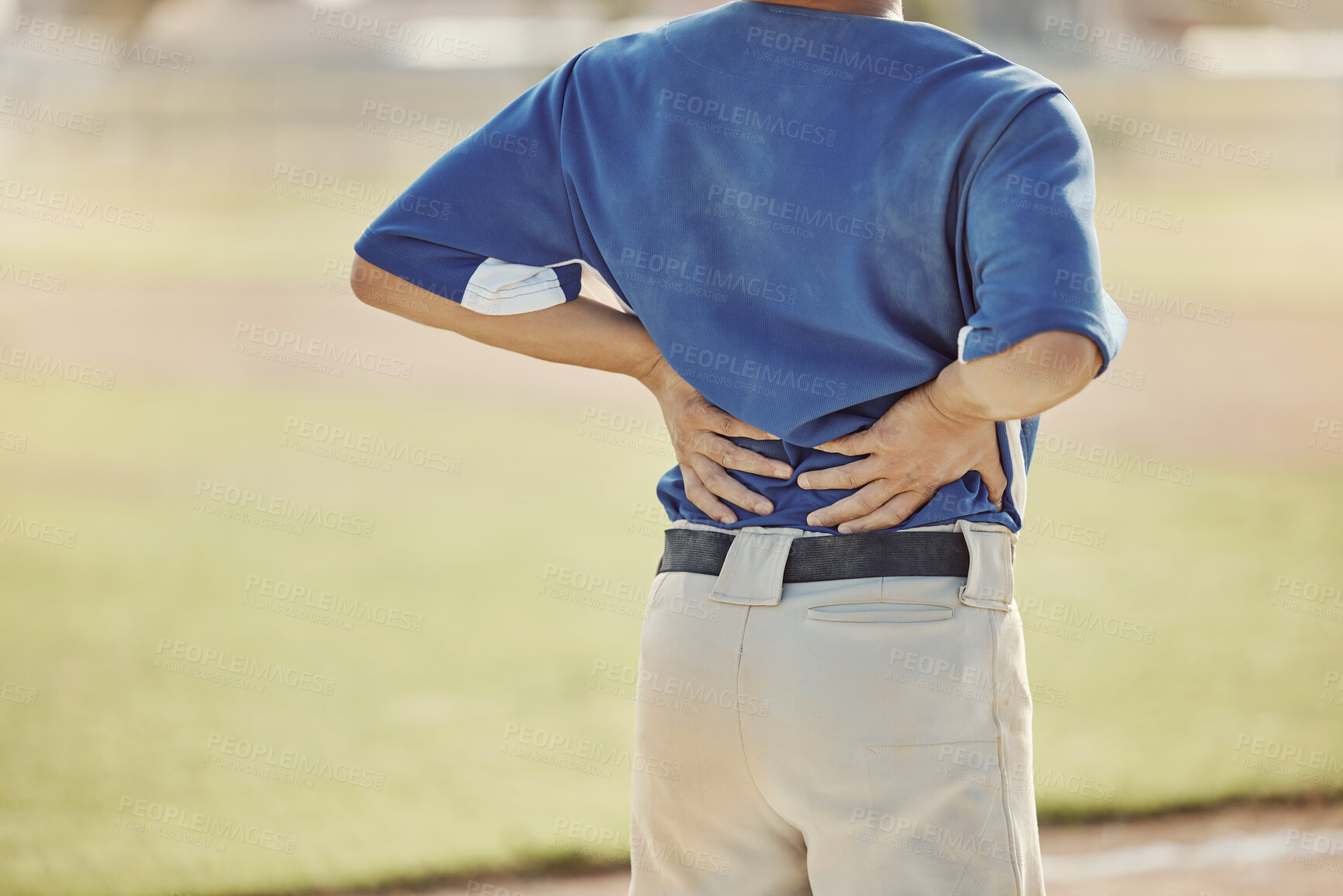 Buy stock photo Sports, baseball injury and man with back pain, emergency or muscle strain during game, competition or fitness match. Softball player, field pitch or back view of athlete with hurt spine or backache