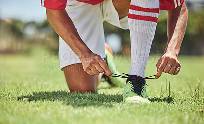 Buy stock photo Hands, shoes and soccer player at a soccer field, tie lace and prepare for training, sports and fitness game. Football, hand and football player getting ready for workout, exercise and sport practice