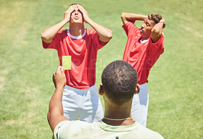 Buy stock photo Sports, soccer and referee with yellow card standing on field with upset, angry and mad soccer players. Foul, mistake and athlete getting warning for rules violation in game or match on soccer field
