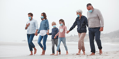 Buy stock photo Big family, covid and holding hands walking on beach for quality bonding time together during pandemic in nature. Hand of parents, grandparents and kids in travel, freedom and family walk with masks