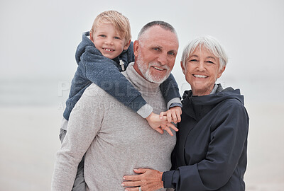 Buy stock photo Family, portrait and child with grandparents at a beach, hug, relax and smile while having fun on vacation. Travel, happy family and senior couple enjoy ocean trip and quality time with grandchild