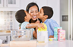 Happy, mother and children kissing cheek for love, baking and mothers day celebration in the kitchen at home. Mama smile with little boys in joyful happiness, care and sweet treatment for parent