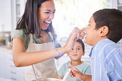 Buy stock photo Family, mom and cooking in kitchen with children, having fun and bonding in home. Happy, smile and mother playing with boys, care and spending quality time together, helping and learning how to cook.