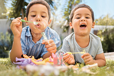 Buy stock photo Brothers kids blowing bubbles in park, garden and backyard, grass and nature fun, joy and happy youth development, growth and relax. Young brothers, happy children playing game and soap bubbles