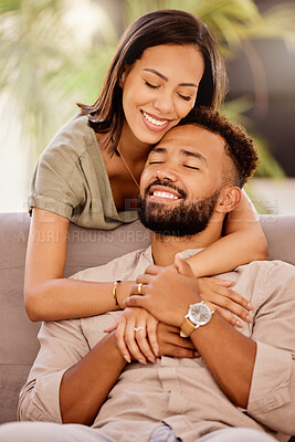 Buy stock photo Happy, love and hug with a black couple on the sofa to relax in the living room of the home together. Smile, happy and hugging with a male and female bonding in the lounge of their house for romance
