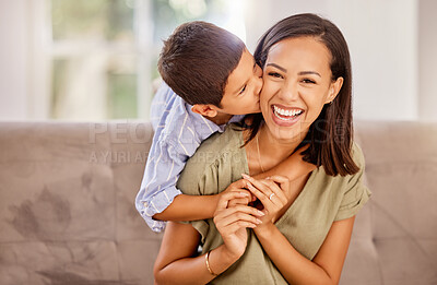 Buy stock photo Kiss, mother and child with hug for love, care and gratitude on mothers day on the sofa of the living room in their house. Portrait of a happy, young and mom with a smile for affection from her kid