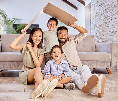 Buy stock photo Family, children and insurance with a mother, father and boy siblings sitting under cardboard in the living room of the home together. Kids, love and cover with a boy, brother and parents in a house