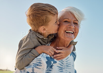 Buy stock photo Kiss, child and grandmother in a park with love, care and freedom for happiness in retirement. Senior, smile and portrait of a woman with hug from a kid and kissing in nature or park with piggyback
