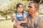Bubble wand, park and love with a father and daughter bonding, playing or having fun outdoor during summer. Family, kids and smile with a happy girl and her single dad playing together outside