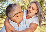 Woman, senior man and surprise in park, shocked and excited hug in outdoor garden on summer holiday weekend. Love, retirement and nature, a happy elderly couple embrace with grass, smile and trees.