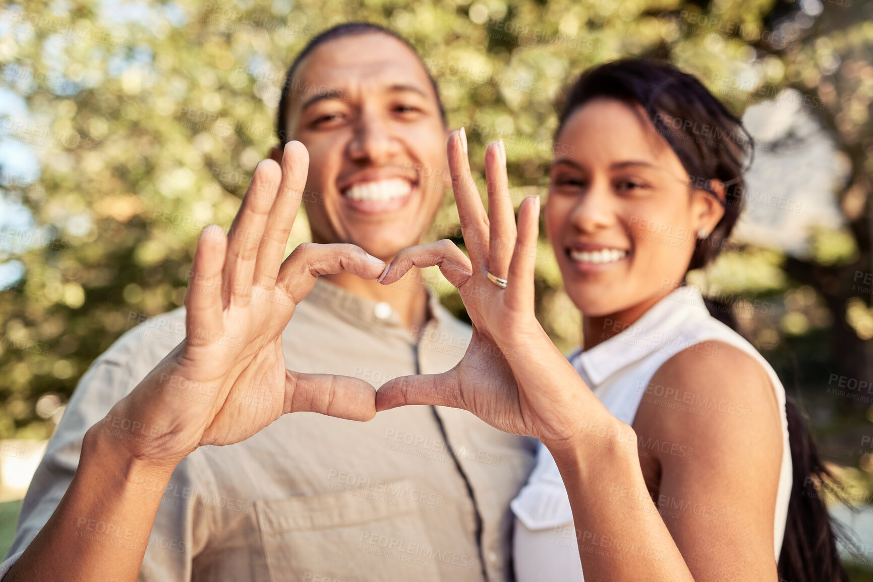 Buy stock photo Hands, heart and love with a black couple sign outdoor in the garden of their home together. Happy, hand and romance with a man and woman making a shape with their fingers while bonding outside