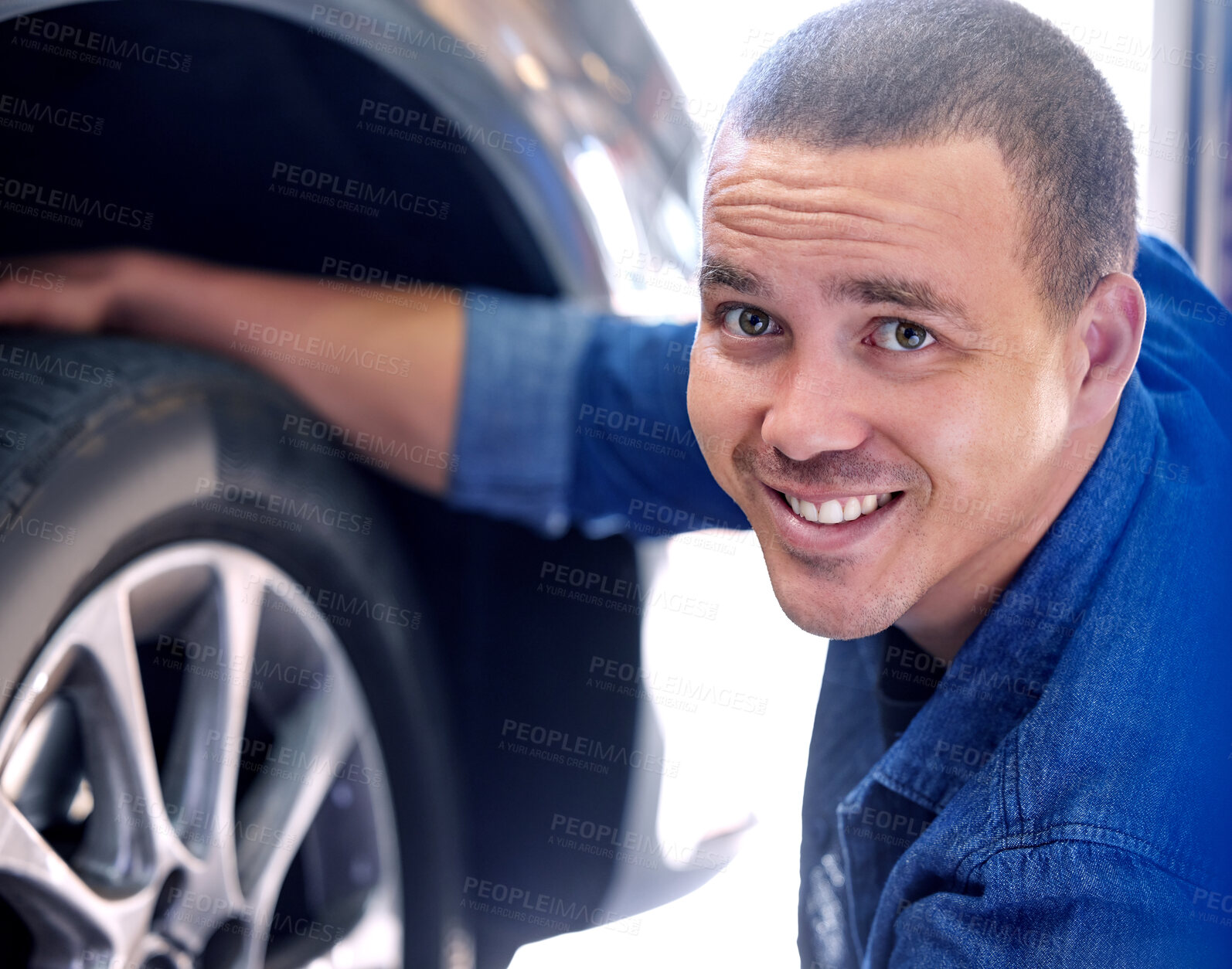 Buy stock photo Mechanic, tire change and happy man car service assistant in automobile shop or road side assistance. Wheel safety, break pad inspection and professional automobile maintenance worker in motor garage