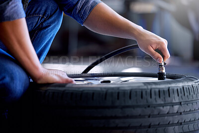 Buy stock photo Air pressure, tire and mechanic working in garage with pump in hand. Man in auto service, vehicle care and checking car wheel in workshop. Technician doing maintenance check in motor repair industry