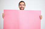 Portrait of man with poster, banner or paper sheet for marketing, advertising or product placement mockup. Happy, smile and person holding a pink mock up billboard for promotion on white background