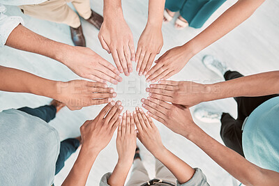 Buy stock photo Hands, collaboration and motivation with a business team standing in a huddle or circle from above. Teamwork, goal and unity with a man and woman employee group together in the office for support